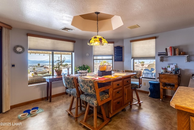 dining room featuring tile patterned floors, visible vents, baseboards, and a textured ceiling