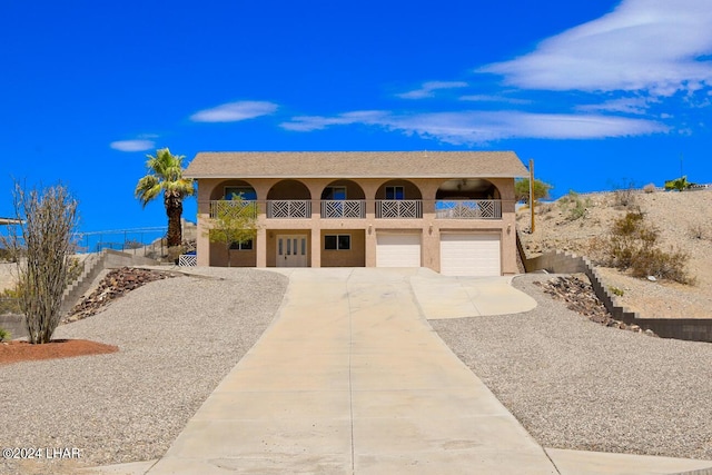 view of front of property with a garage and a balcony