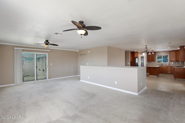 unfurnished living room featuring light carpet, ornamental molding, and ceiling fan