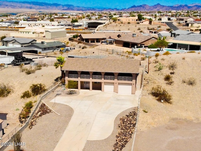 birds eye view of property with a mountain view