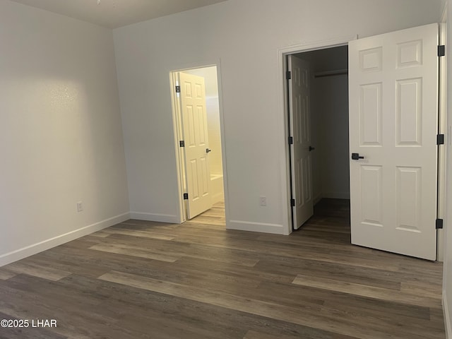 1990 Folzman Dr, Lake Havasu City, AZ 86404 - unfurnished bedroom with a walk in closet, dark wood-style flooring, and ensuite bathroom