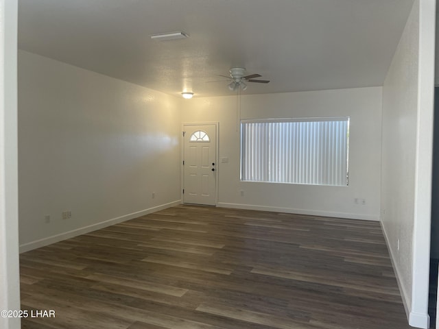 1990 Folzman Dr, Lake Havasu City, AZ 86404 - empty room with a ceiling fan, dark wood-style floors, and plenty of natural light