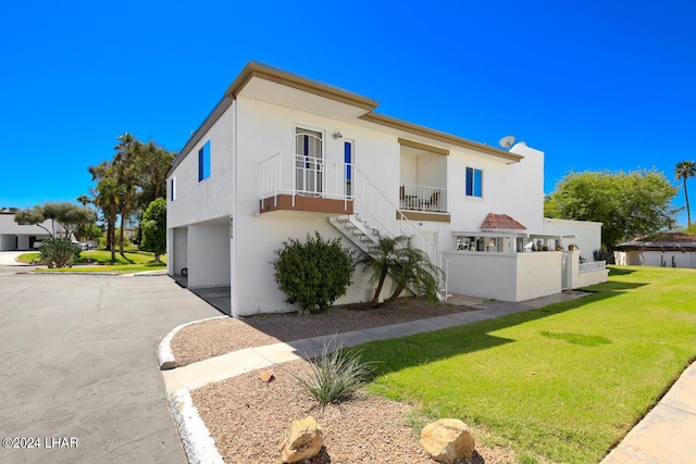 view of front of property with a garage and a front lawn