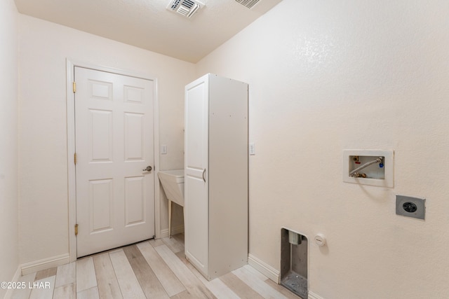 washroom with laundry area, visible vents, hookup for an electric dryer, light wood-type flooring, and washer hookup