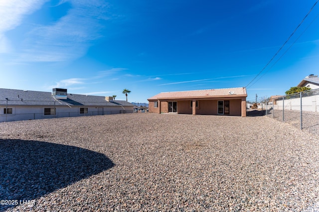 rear view of property with a fenced backyard and central AC unit