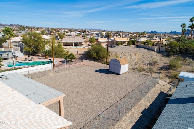 exterior space featuring a residential view, a fenced backyard, and a fenced in pool