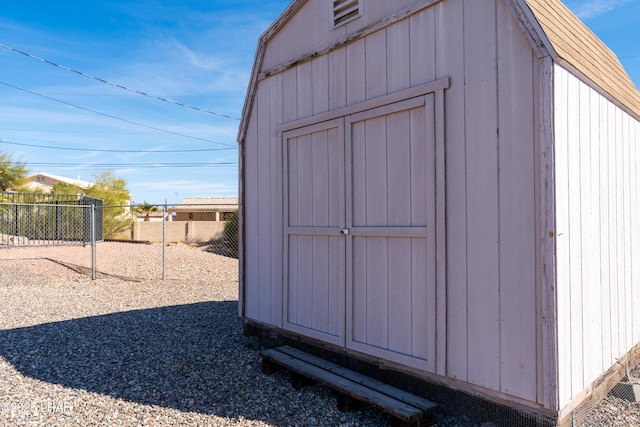 view of shed featuring fence