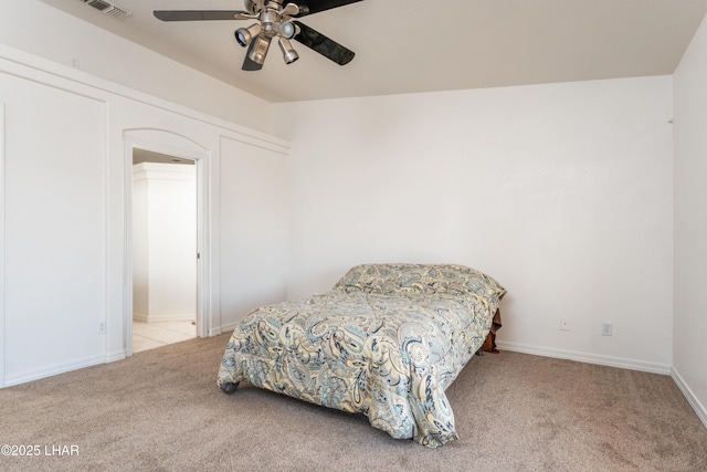 carpeted bedroom featuring ceiling fan, visible vents, and baseboards