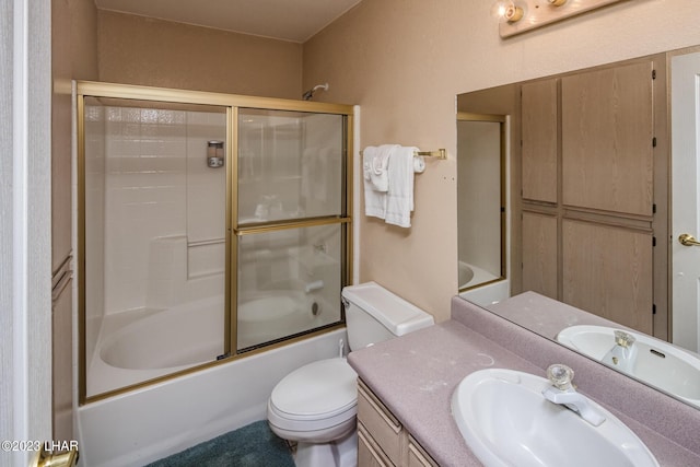 full bathroom with vanity, combined bath / shower with glass door, and toilet