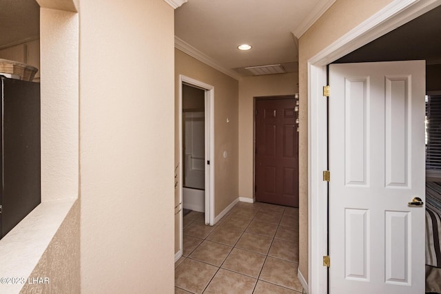 corridor featuring ornamental molding and light tile patterned flooring