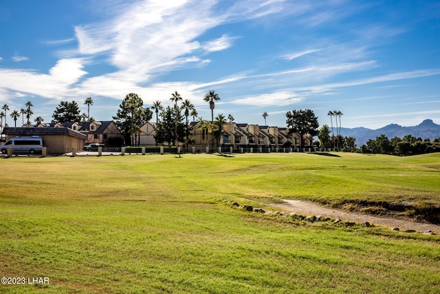 view of community featuring a mountain view and a yard