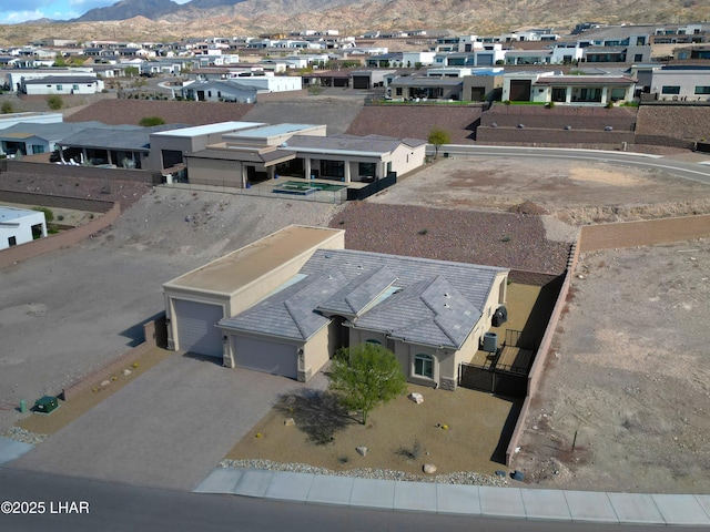 drone / aerial view featuring a mountain view and a residential view