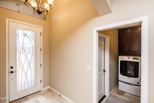 entryway featuring a chandelier, washer / dryer, and baseboards