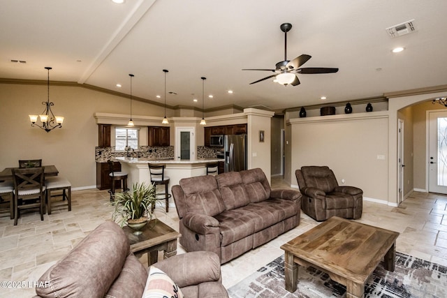 living room with arched walkways, visible vents, stone tile floors, and plenty of natural light