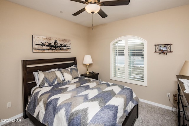 bedroom with a ceiling fan, baseboards, and carpet floors