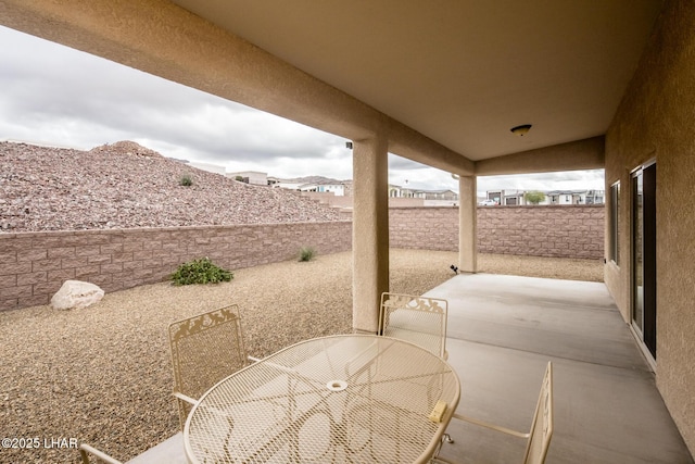 view of patio with outdoor dining area and a fenced backyard