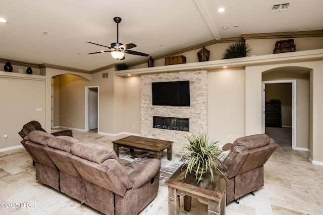 living area with visible vents, vaulted ceiling with beams, stone finish flooring, arched walkways, and a ceiling fan