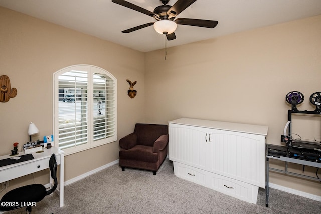 living area featuring baseboards, carpet floors, and ceiling fan