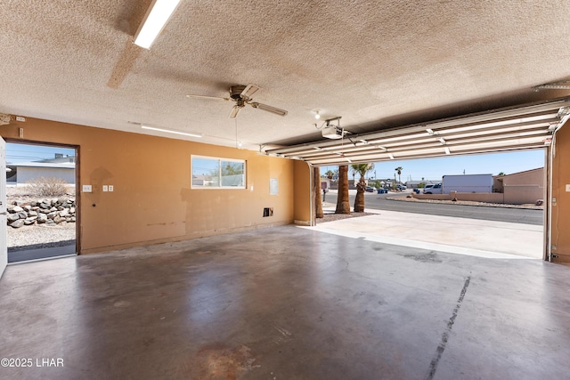 garage with ceiling fan and a garage door opener