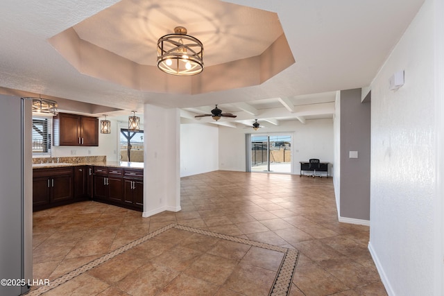 interior space featuring baseboards, a wealth of natural light, and dark brown cabinetry