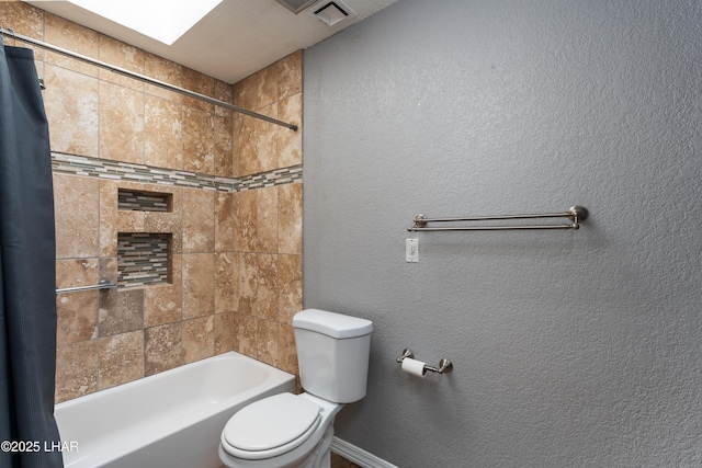 bathroom featuring shower / bath combo with shower curtain and toilet