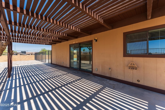 view of patio with a pergola and fence