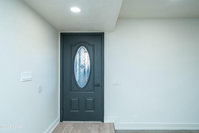 entryway featuring light wood-type flooring and baseboards