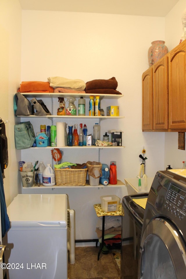 washroom featuring cabinets and separate washer and dryer