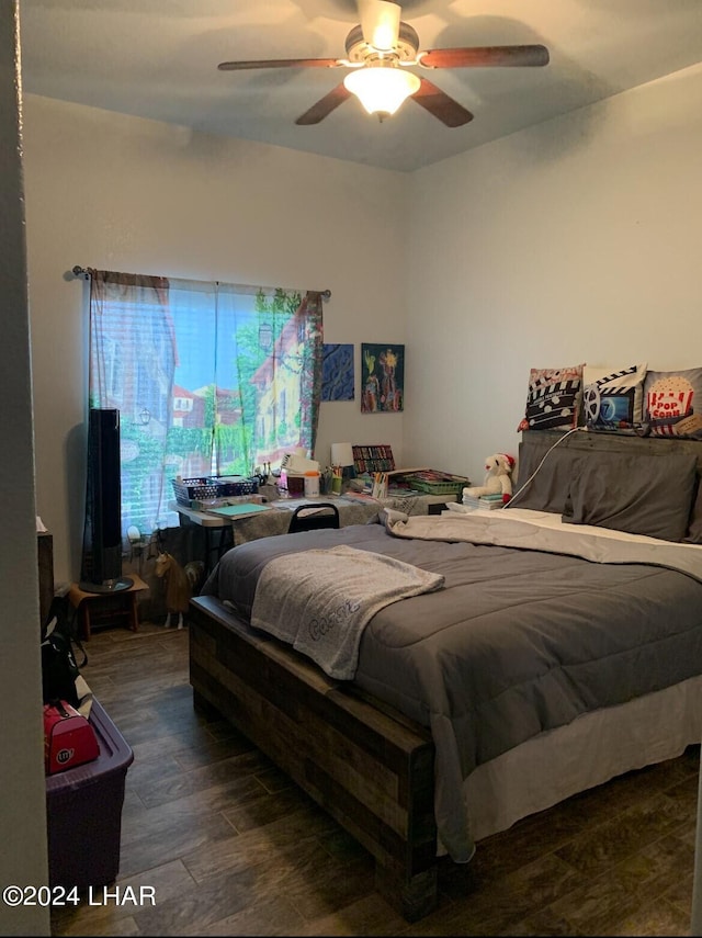 bedroom with dark hardwood / wood-style floors and ceiling fan