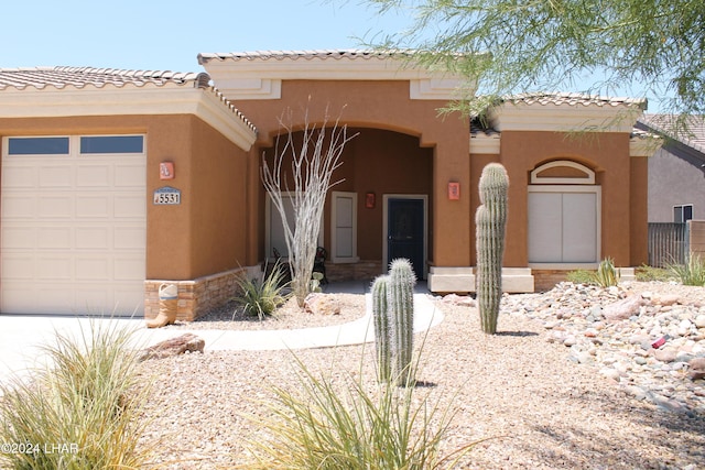 mediterranean / spanish-style house with a garage