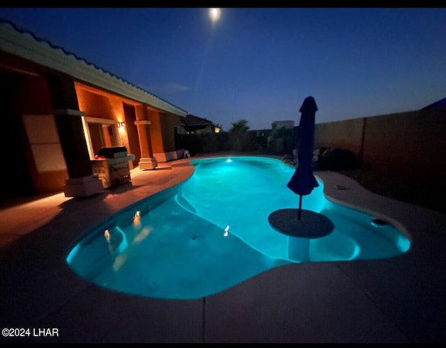 pool at night with a patio