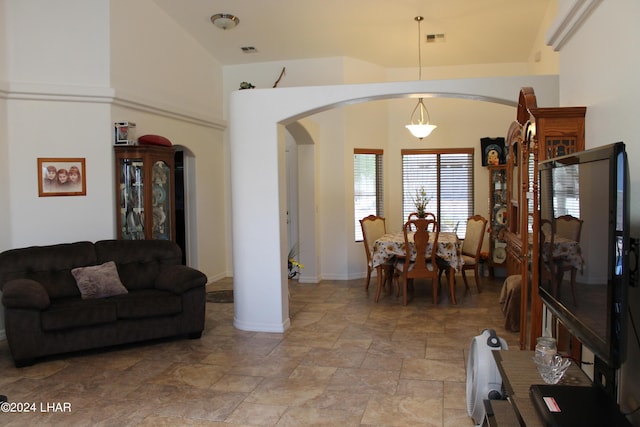 living room featuring a towering ceiling