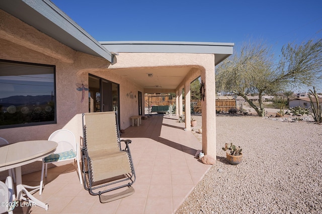 view of patio / terrace featuring fence