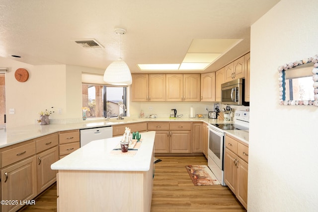 kitchen with white appliances, visible vents, light brown cabinetry, light wood-style floors, and a sink