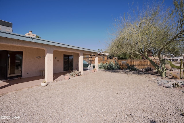 exterior space with fence and a patio