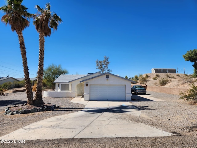 view of front of house featuring a garage, driveway, and stucco siding