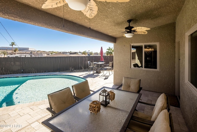 view of swimming pool featuring a patio and ceiling fan