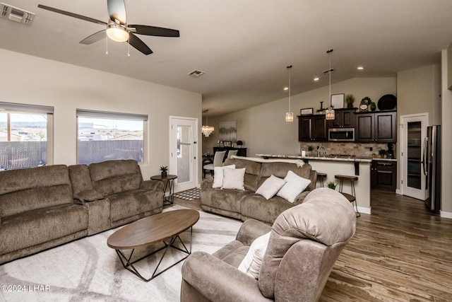 living room with lofted ceiling, dark hardwood / wood-style floors, and ceiling fan