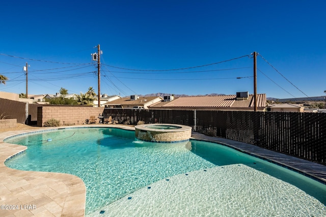 view of swimming pool featuring an in ground hot tub