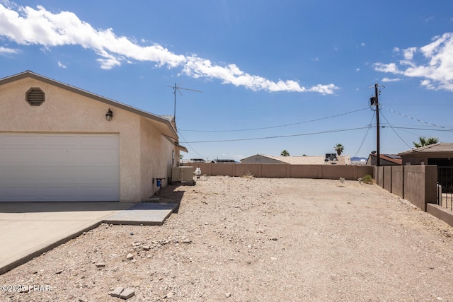 3716 Sloop Ln, Lake Havasu City, AZ 86406 - view of side of property featuring stucco siding and a garage