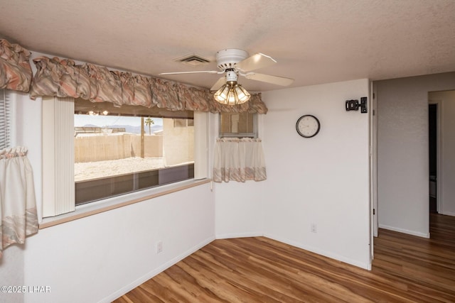 3716 Sloop Ln, Lake Havasu City, AZ 86406 - empty room with wood finished floors, a ceiling fan, a textured ceiling, and baseboards