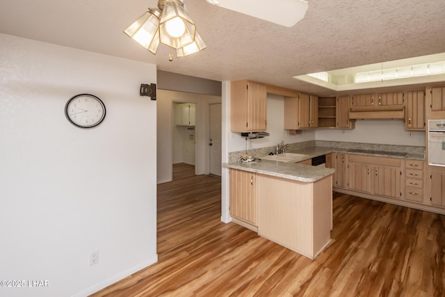 3716 Sloop Ln, Lake Havasu City, AZ 86406 - kitchen with a sink, white oven, a peninsula, light countertops, and black electric cooktop