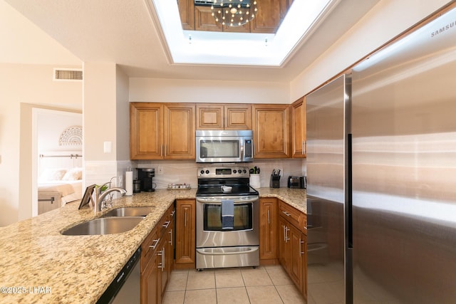 1650 Smoketree Ave S Unit 119, Lake Havasu City, AZ 86403 - kitchen featuring brown cabinets, light tile patterned flooring, appliances with stainless steel finishes, a sink, and visible vents