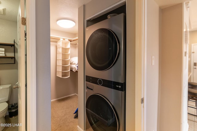 1650 Smoketree Ave S Unit 119, Lake Havasu City, AZ 86403 - laundry area featuring carpet flooring, laundry area, baseboards, and stacked washer and clothes dryer
