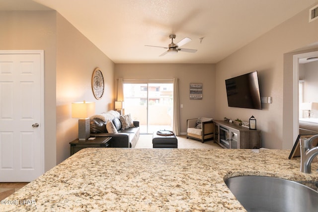 1650 Smoketree Ave S Unit 119, Lake Havasu City, AZ 86403 - kitchen with a ceiling fan, open floor plan, light stone counters, and a sink