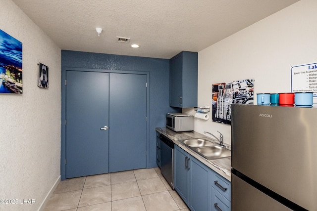 1650 Smoketree Ave S Unit 119, Lake Havasu City, AZ 86403 - kitchen with blue cabinetry, a textured ceiling, appliances with stainless steel finishes, a sink, and light tile patterned floors
