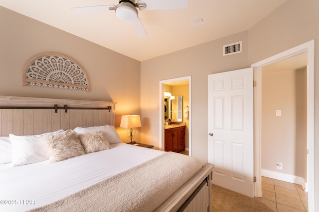 1650 Smoketree Ave S Unit 119, Lake Havasu City, AZ 86403 - bedroom featuring visible vents, baseboards, ensuite bathroom, a ceiling fan, and light tile patterned floors