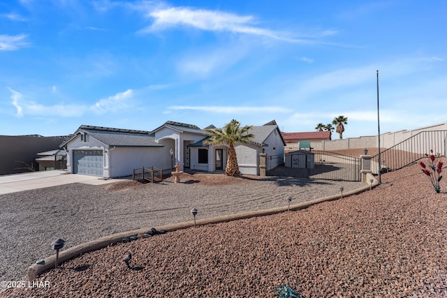 view of front of house with a fenced front yard, concrete driveway, stucco siding, a garage, and a gate