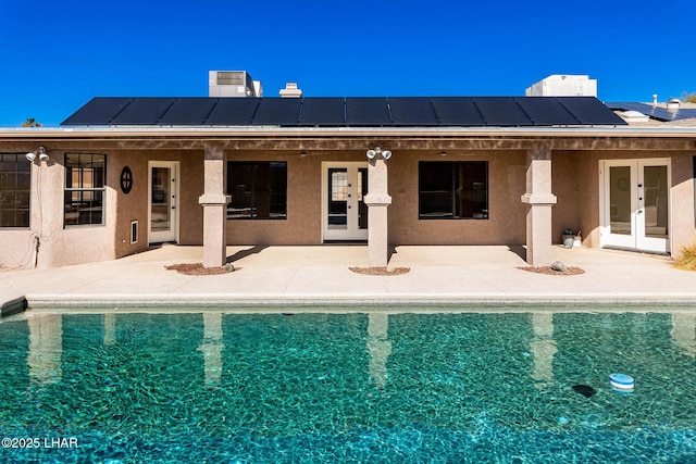 view of swimming pool featuring a patio area and french doors