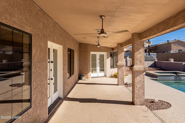 view of patio / terrace featuring a pool with hot tub, french doors, and ceiling fan